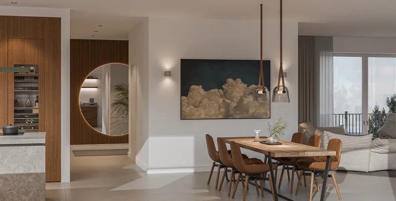 Essbereich des Penthouses mit langer Tafel und rundem Wandspiegel.